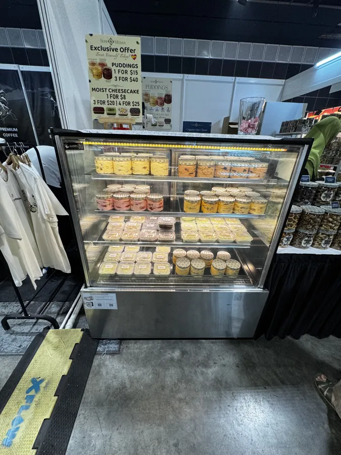 AANRS cake chiller rental Singapore, stainless glass display packed with cups of pudding and cheesecake at an event stall