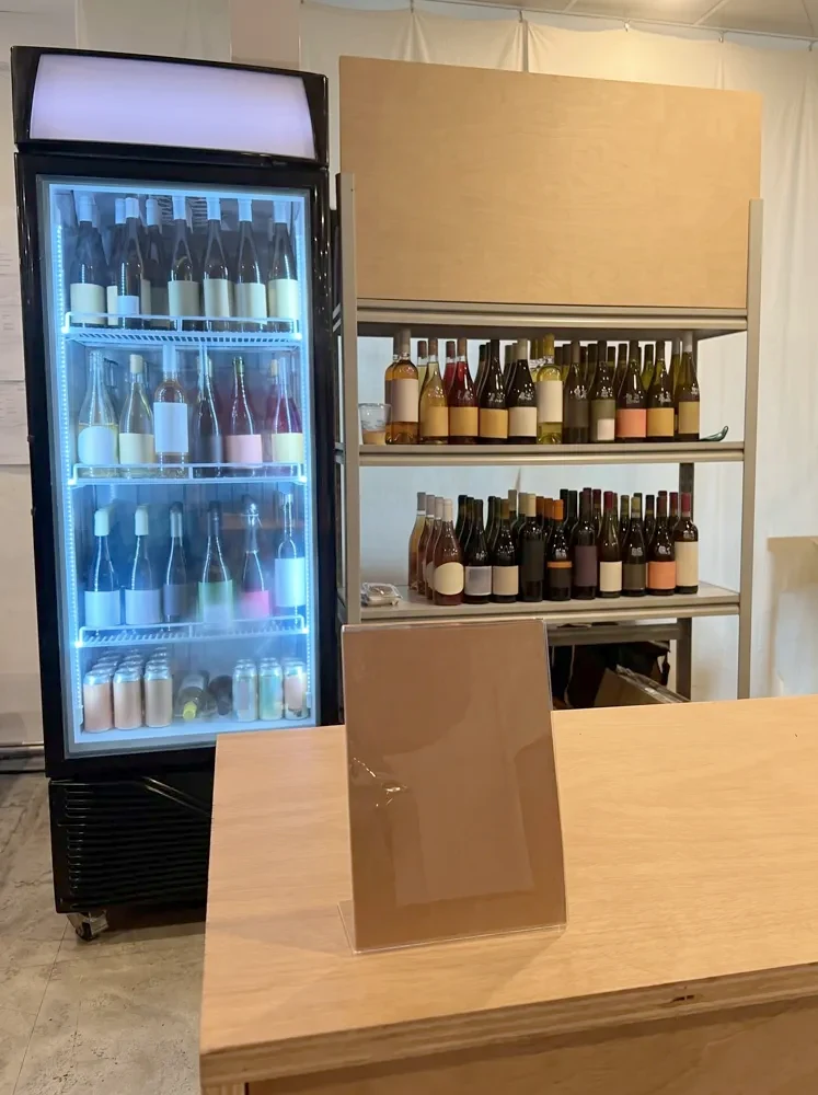 Wine chiller at a blue-lit tasting event